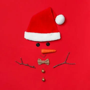 Funny snowman made with different elements on red background, flat lay 스톡 사진