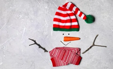 Funny snowman made with different elements on light grey marble background, f Stock Photos