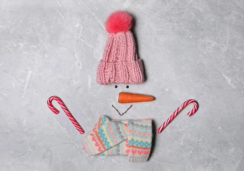 Funny snowman made with different elements on light grey marble background, f 스톡 사진