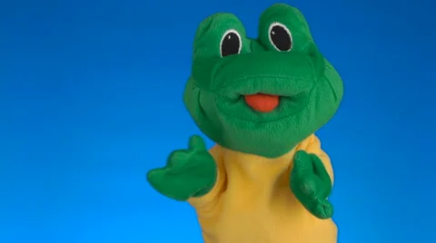 Funny soft puppet frog on blue background Stock Footage 62893057