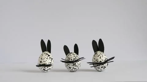 Funny spotted Easter eggs decorated as bunnies appear on the white background. Stock Footage 172453624