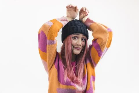 Funny studio portrait of pink-haired caucasian teenage girl in a black beanie Stock Photos