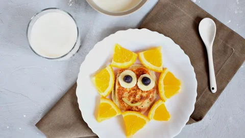 Funny sun face shape snack from pancake,orange on plate. Cute kids childrens Stock Footage 278741384