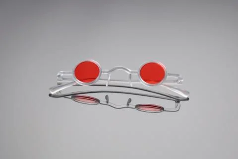 Funny sunglasses with white plastic frames and red lenses Stock Photos