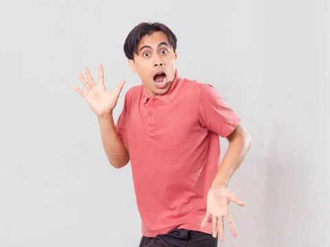 Funny surprised face expression of Asian man looking at camera, isolated on.. Stock Photos