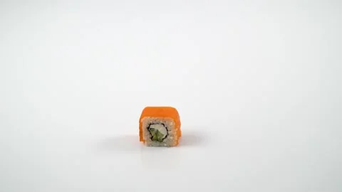 Funny Syrian hamster on a white background. Syrian hamster eats sushi or roll 動画素材 133876487