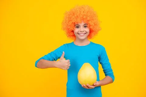 Funny teenage girl hold citrus fruit pummelo or pomelo, big grapefruit isolated Stock Photos