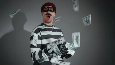 Funny thief in mask and Prison Uniform throws banknotes Stock-Footage 222811566