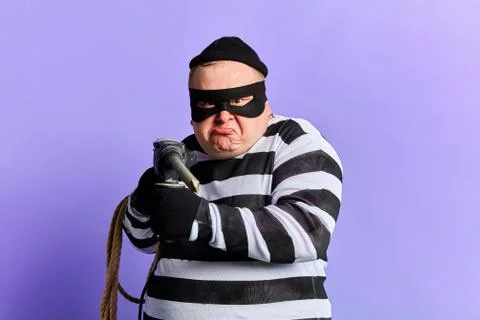 Funny thief using a punch to steal money Stock Photos