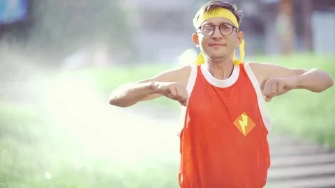 Funny thin freak man doing exercises in the park Stock Footage 82824629