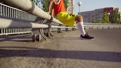 A funny, thin man makes a warm-up before jogging Stock Footage 79078580