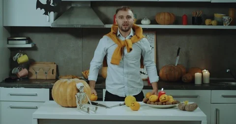 Funny time in the kitchen a man prepare the decoration for Halloween party, he Stock-Footage 96418022