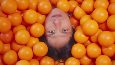 Funny top down shot of man's face in ball pit Stock Footage 272321252