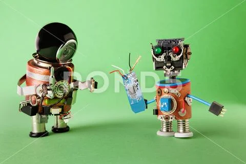 Funny toy robots with tech accessories. Handyman screwdriver and technicia Stock Photos