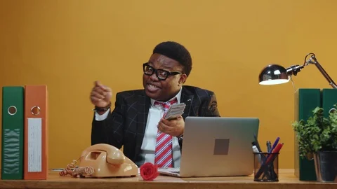 Funny tricky afro-american manager with money throwing in rain playing at camera Stock Footage 125128469