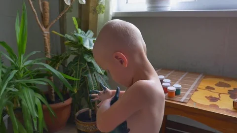 Funny two year old dirty boy painting with his fingers on his body Video stock 79931909