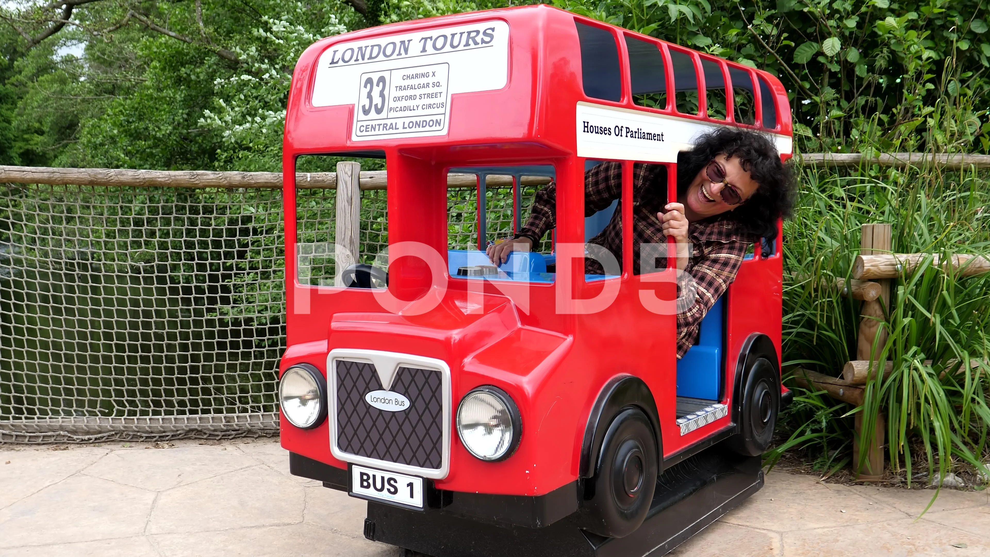 Funny video of adult woman inside small red bus