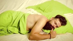 Funny Man lying in bed and sleeping. Att... | Stock Video | Pond5
