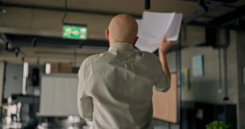 Funny video shows office worker jumping and waving papers with charts during his Видео 313274949