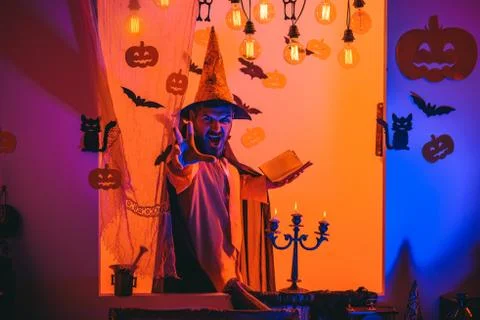 Funny wise wizard on a Halloween background. Wizard, sorcerer, warlock. Mystery Stock Photos