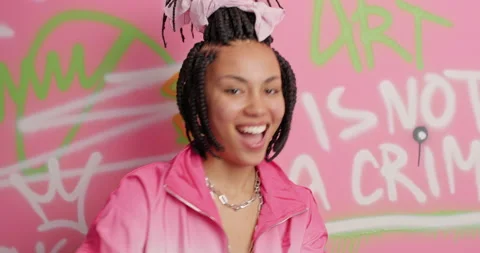 Funny woman with dreadlocks dances actively shows rap gesture shows street dance Stock Footage 150704341