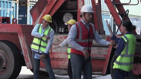 Funny workers and engineer dance at cargo containers Stock Footage 168999813