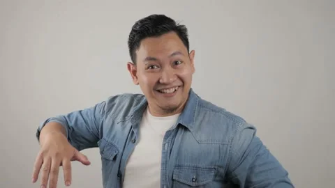 Funny young Asian man dancing happily joyful expressing celebrating good news Stock Footage 143762382