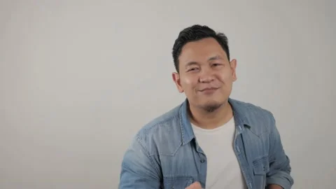Funny young Asian man dancing happily joyful expressing celebrating good news Vídeo Stock 143762544