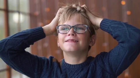 Funny young boy combing his head with his hands and smiling. Stock Footage 161153336