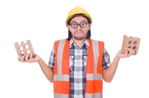 Funny young construction worker with broken brick isolated on white Stockfoto's