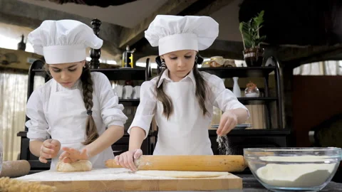 Funny young girls are preparing the dough in the kitchen Stock Footage 149991253