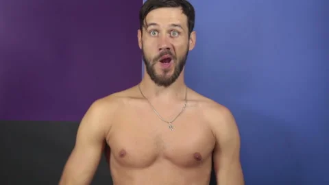 A funny young guy with a naked torso sho... | Stock Video | Pond5
