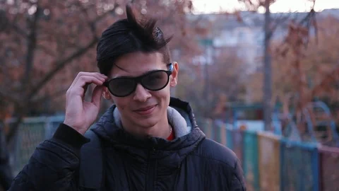 Funny young man in 3D glasses standing on the street, close up 動画素材 98359162