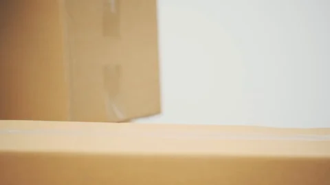 Funny young man is appearing from behind the cardboard box, looking around Stock Footage 120180103