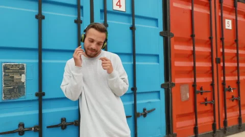 Funny young man dancer moves to music of waves makes his hands, smiling Stock Footage 155074468