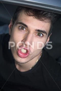 Funny Young Man Face with Pouting Lips and Wide Eyes Stock Photos