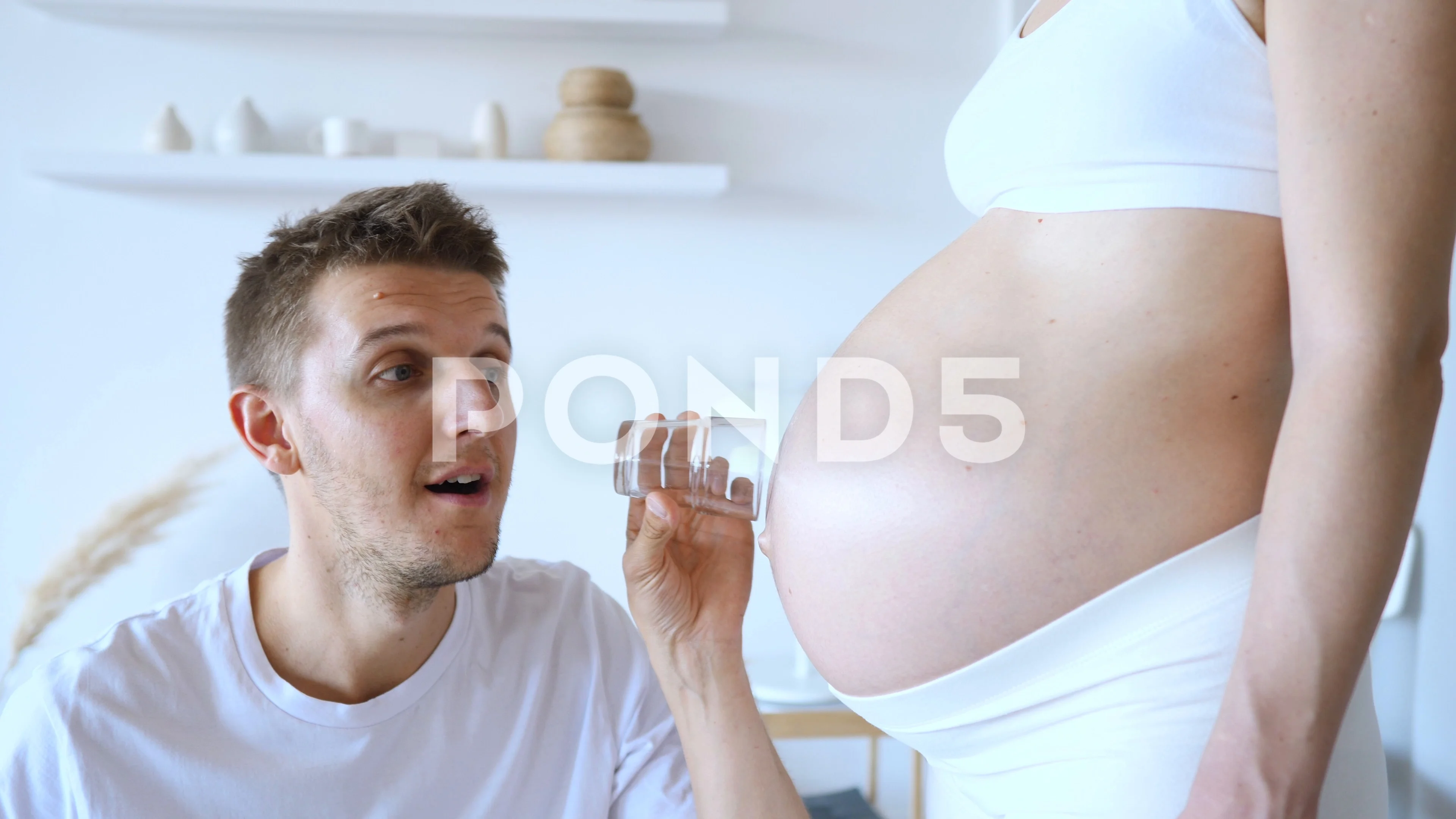 Funny Young Man Listening To His Pregnan... | Stock Video | Pond5