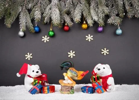 Fur-tree branches, balls, snowflake, rooster, presents, bear and snow on gray ba Photos