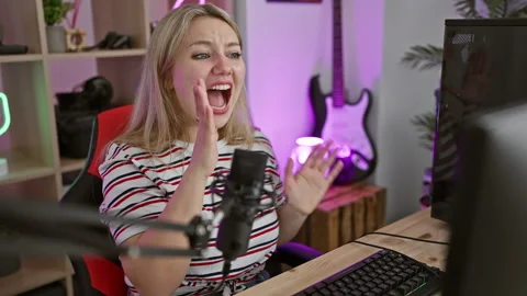 Furious blonde streamer yelling loud in gaming room, wave of stress showing.. Stock Footage 272953300