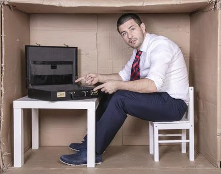 Furious businessman points to an empty briefcase Stock Photos