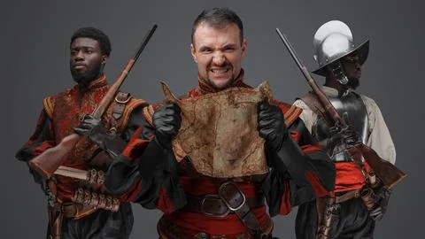 Furious conquistador explorer with map with two comrades Stock Photos