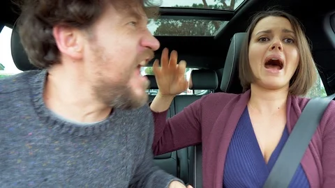 Furious couple in car angry with driver in traffic shouting closeup Stock Footage 87756385