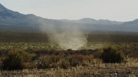 Furious dust devil rips through the scrub and sage of the Mojave Desert. Stock Footage 188628444