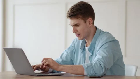 Furious guy screaming at laptop with software error at home Stock Footage 275281090
