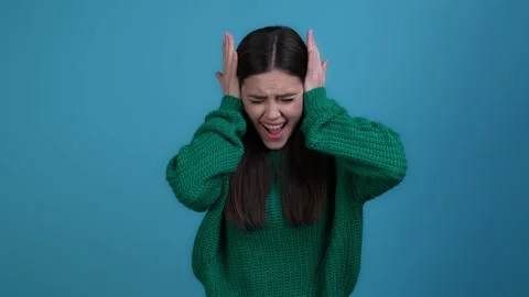 Furious lady hide palms ears suffer music isolated dark color background Stock Footage 167219486