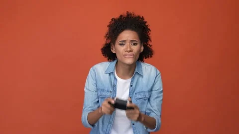 Furious lady play joy stick lose competition isolated brick color background Stock Footage 167356052
