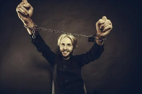 Furious man with chained hands, no freedom Stock Photos