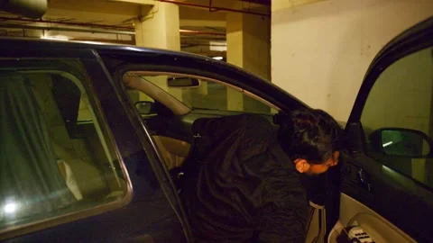 Furious man exits car after parking in basement Stock Footage 310285061
