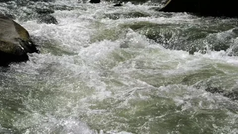 Furious power of mountain river that flows crashing against rocks, close-up Stock Footage 255841745