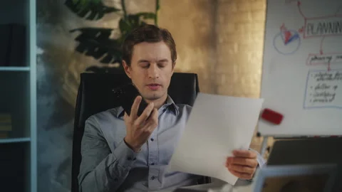 Furious young CEO talks to employee on phone about failed company contract Stock Footage 343923282